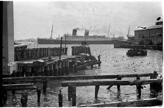 [Ship leaving pier.]