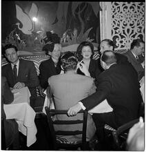 Champagne Cholly Book Party [People talking at a table.]