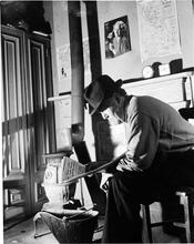 Man Reading near Pot-bellied Stove