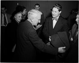 Dale Carnegie [Dale Carnegie speaking with a group of people.]