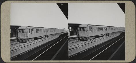 Elevated train arriving at station.
