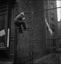 Shoe Shine Boy [Mickey climbing a fence.]